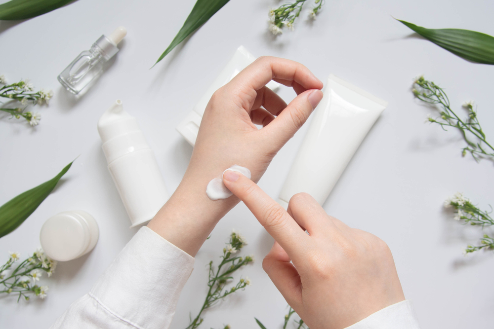 Scientist/pharmacist applying moisturiser lotion on her hand