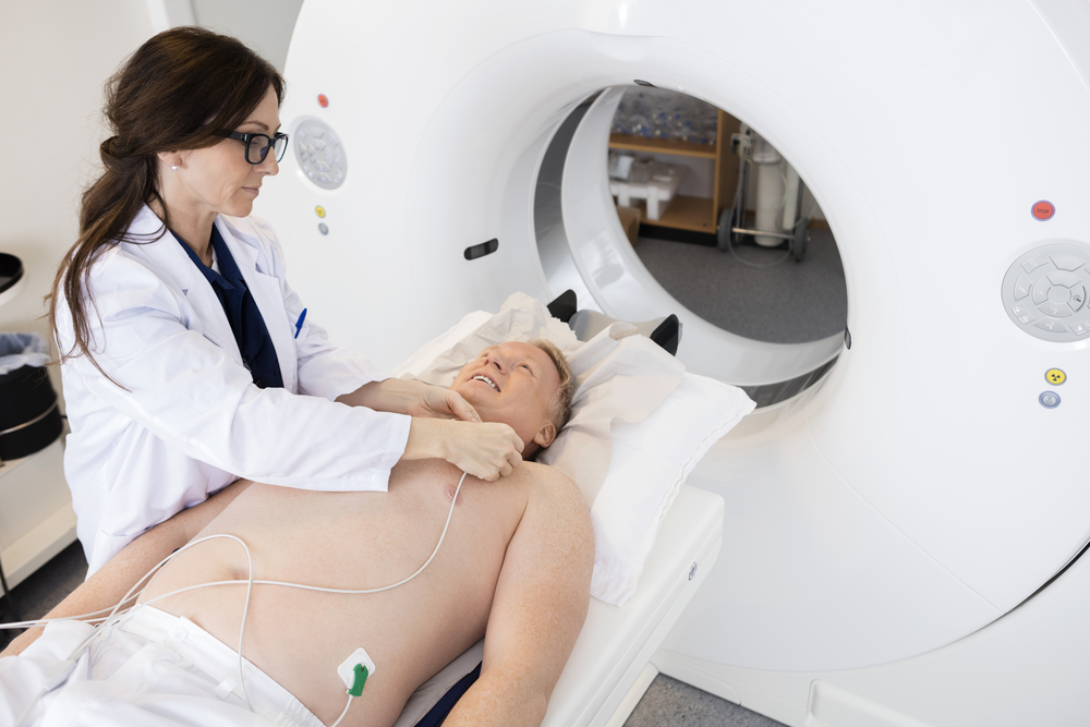 Doctor preparing patient for a CT scan in a hospital setting
