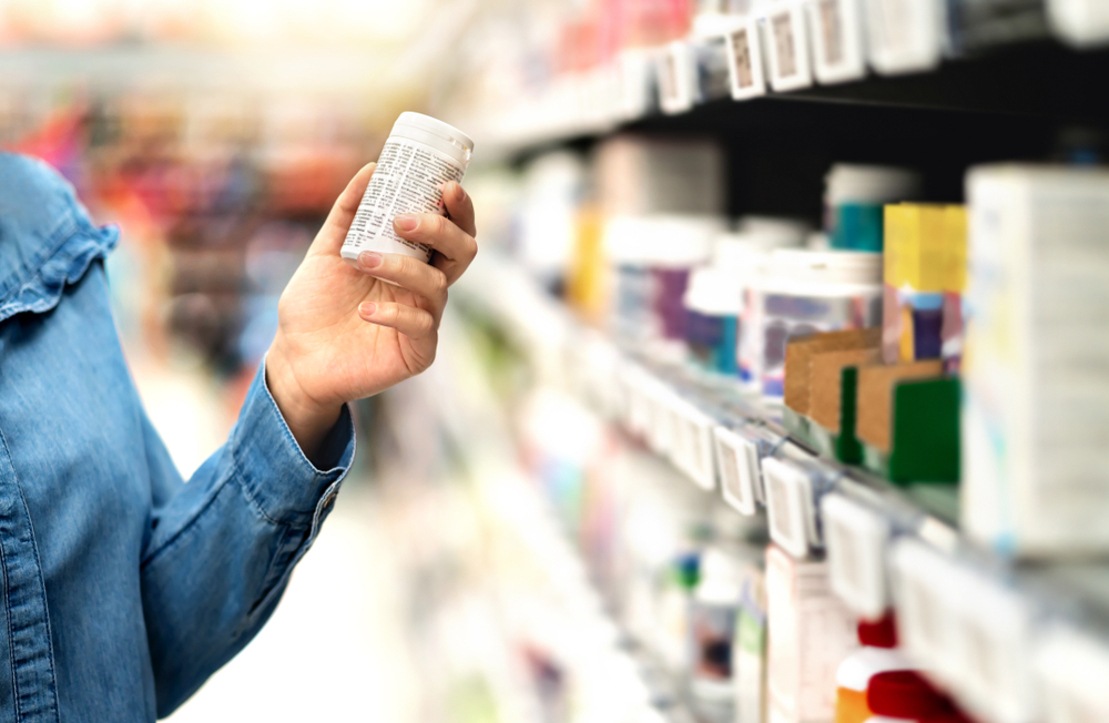 Woman reading the label text about medical information